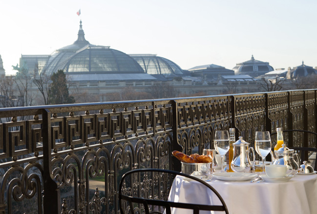 At La Reserve Paris, couples can meals on the property's rooftop overlooking the Grand Palais museum.