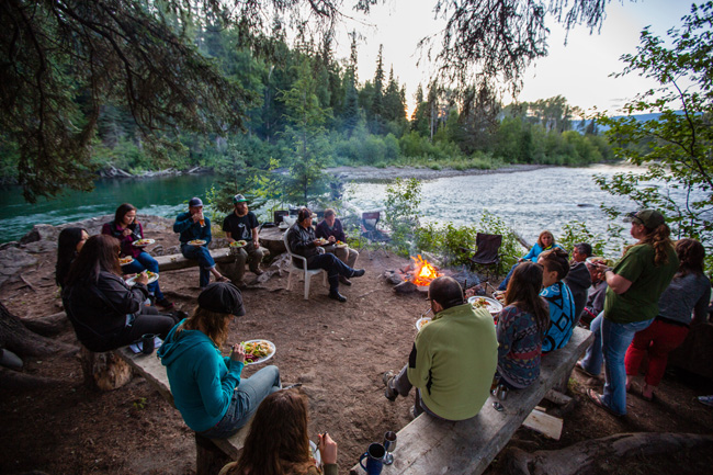 Guests enjoying a meal by the campfire at Bear Claw Lodge in Canada's Kispiox Valley.