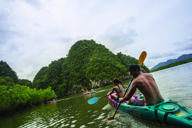 Travelers kayaking in Thailand with G Adventures. (Photo credit: G Adventures.)