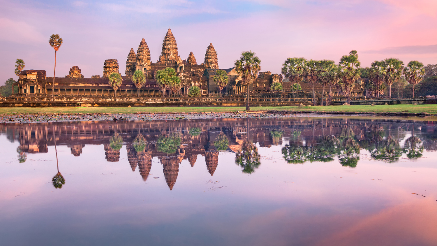 Angkor Wat temple at dramatic sunrise reflecting in water. (Insight Vacations)
