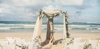 Colin Cowie Wedding Collections' Driftwood Romance ceremony features neutral earth tones and rich foliage.