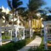 The path to the Ocean Front Suites at Iberostar Grand Hotel Paraiso is lined with palm trees and cozy cabanas.