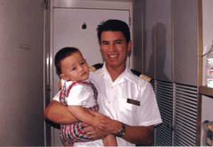 Andy Stuart on board a ship with one of his children.